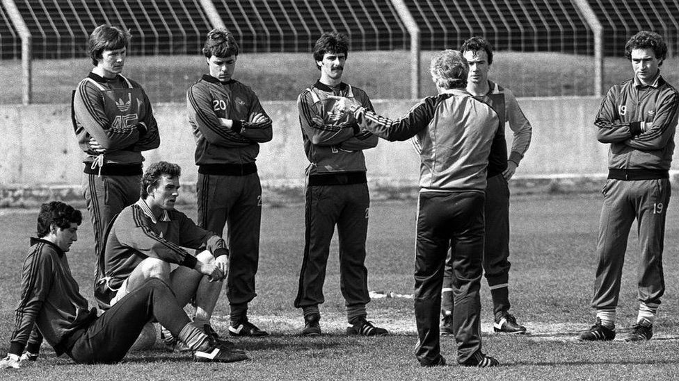 Jim Platt (far left sitting down) and various members of the Northern Ireland squad receive instructions during a training session