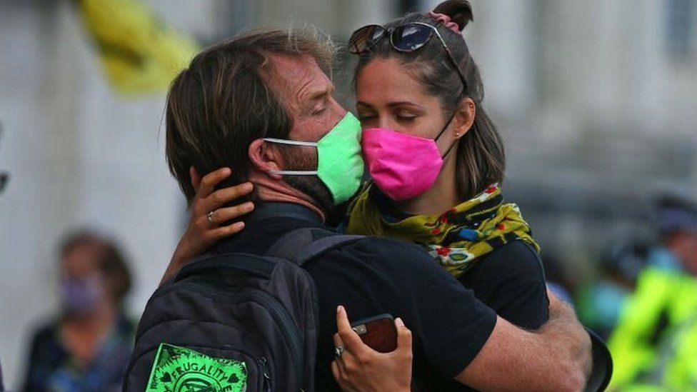 Climate demonstrators hug in Trafalgar Square