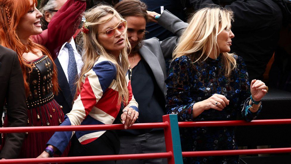Kate Moss and Patsy Kensit on a 1990s bus in a parade during the Platinum Jubilee Pageant