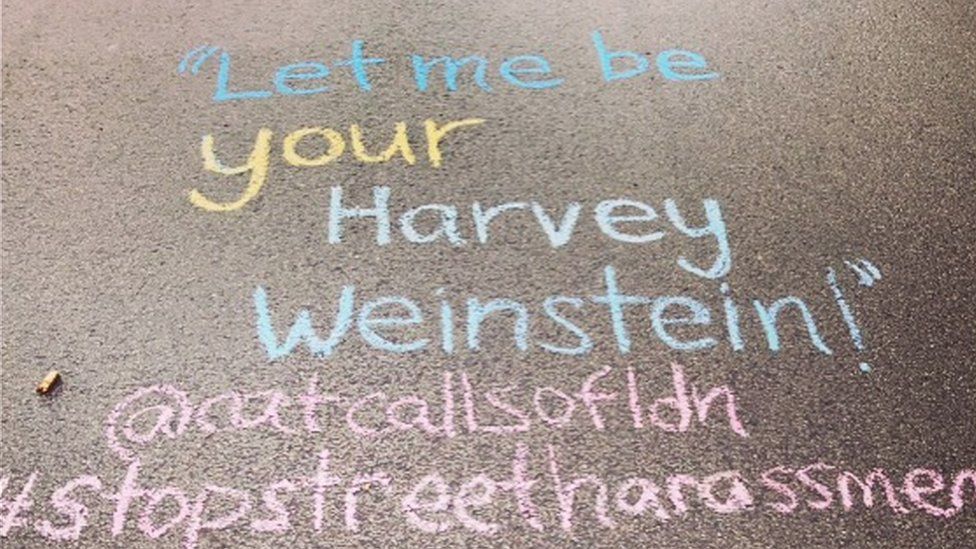 A catcall reading "Let me be your Harvey Weinstein" written on the ground