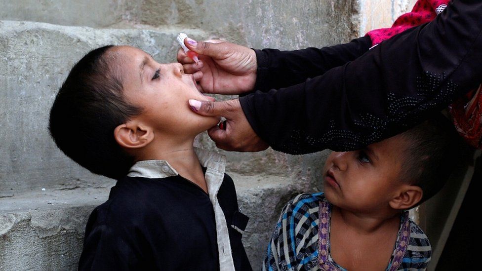A boy receives polio vaccine drops during an anti-polio campaign in Karachi, Pakistan April 9, 2018