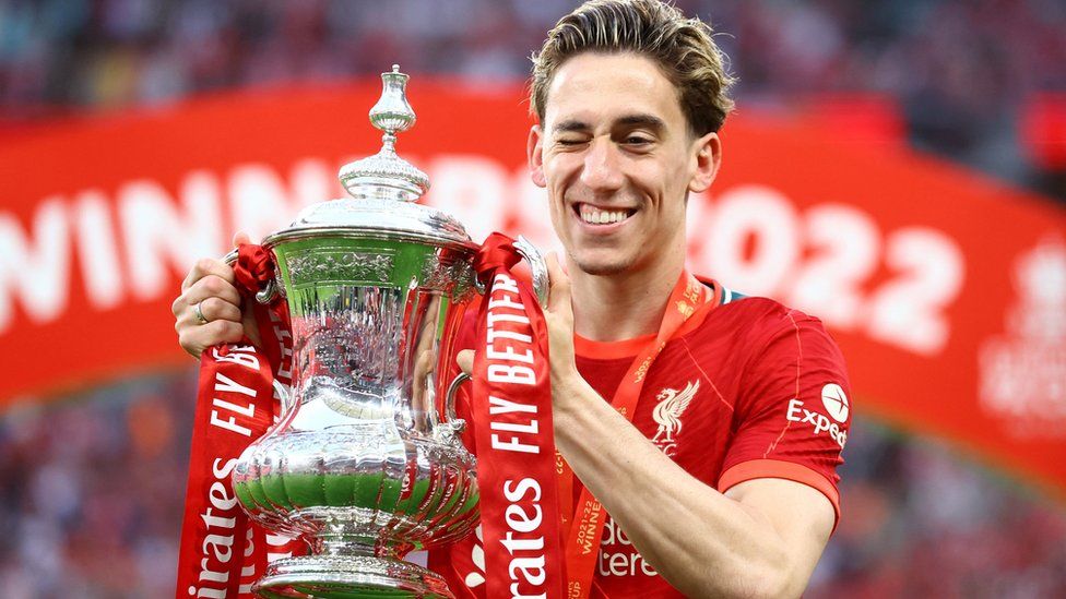 Liverpool"s Kostas Tsimikas celebrates with the trophy after winning the FA Cup final