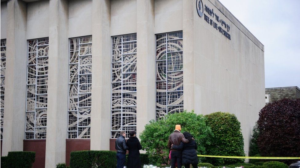 Mourners place flowers outside the Tree of Life synagogue