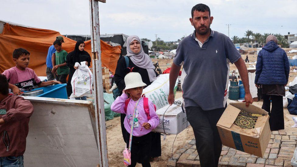 Palestinians pack their belongings as they prepare to flee Rafah in southern Gaza