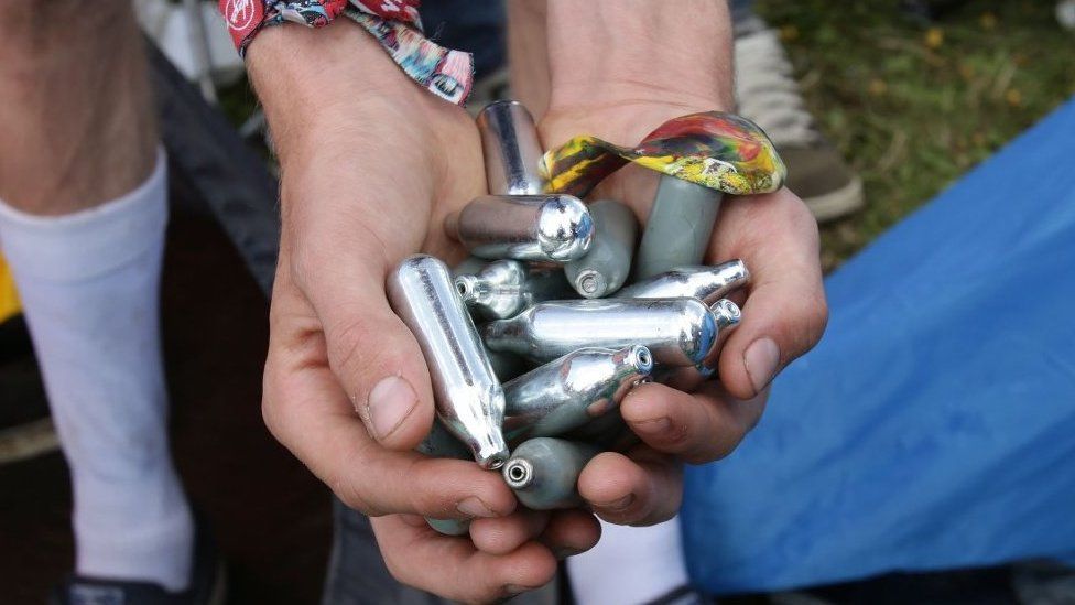 Discarded nitrous oxide cylinders at a music festival