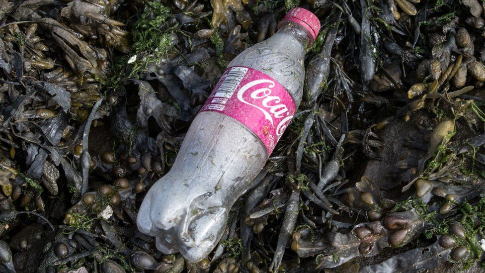 Coca-cola bottle on the beach