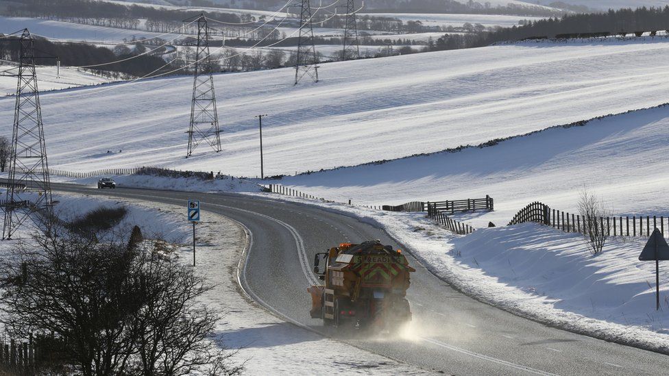 A gritter lorry on a road in Scotland