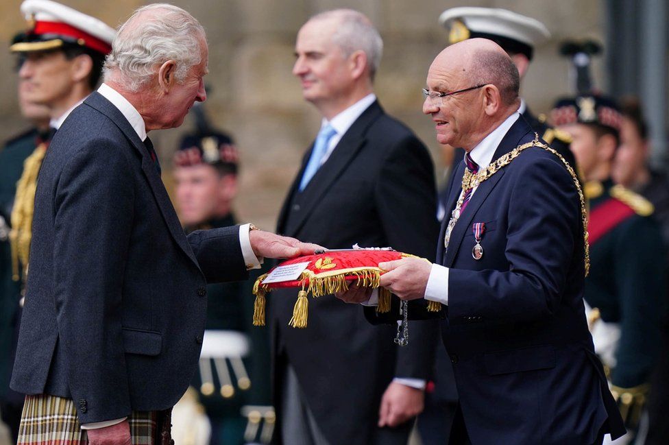 King Charles III received the Keys to the City of Edinburgh from Lord Provost Councillor Robert Aldridge during the Ceremony of the Keys on the forecourt of the Palace of Holyroodhouse