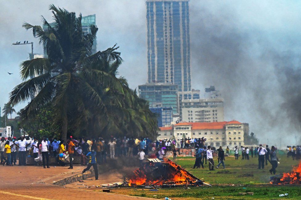 Demonstrators and government supporters clash outside the President's office in Colombo on May 9, 2022.