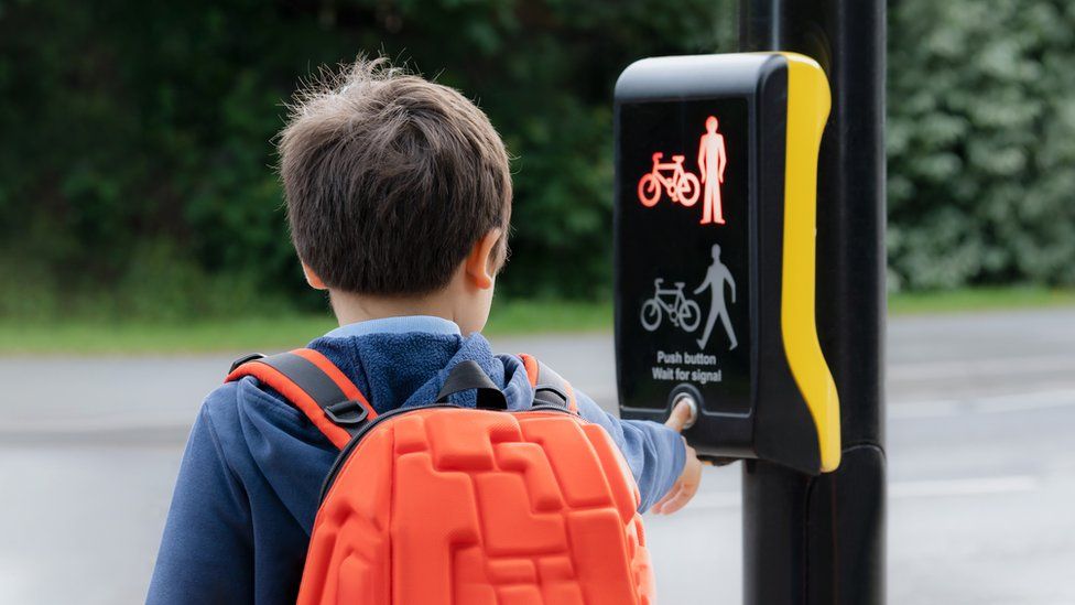 Boy at pedestrian crossing