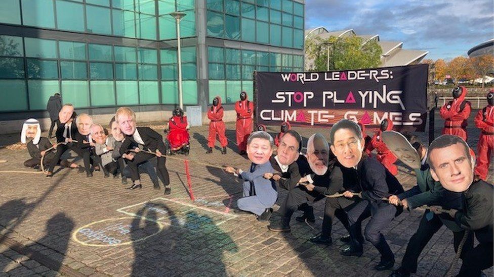 World leaders depicted playing tug-of-war in a climate protest