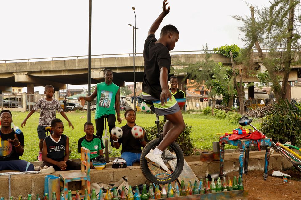 A child practises acrobatics on a unicycle in Lagos, Nigeria - Monday 14 August 2023