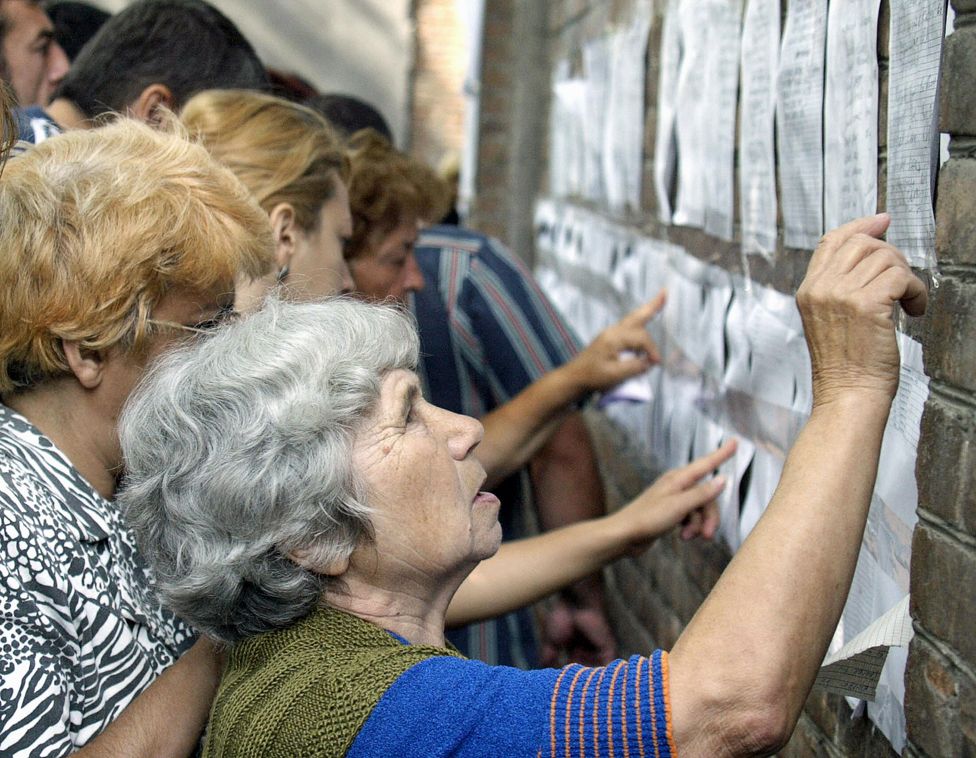 Relatives check the lists of injured at the hospital in the town of Beslan, 4 September 2004