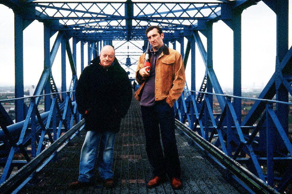 Actors Jimmy Nail and Tim Healy atop the bridge