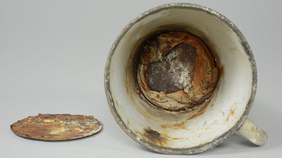 Double bottomed cup found secreting jewellery, at the Auschwitz museum, on 18 May 2016