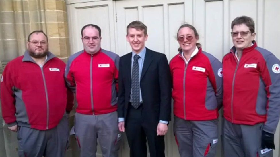 Thomas Milburn with Red Cross volunteers