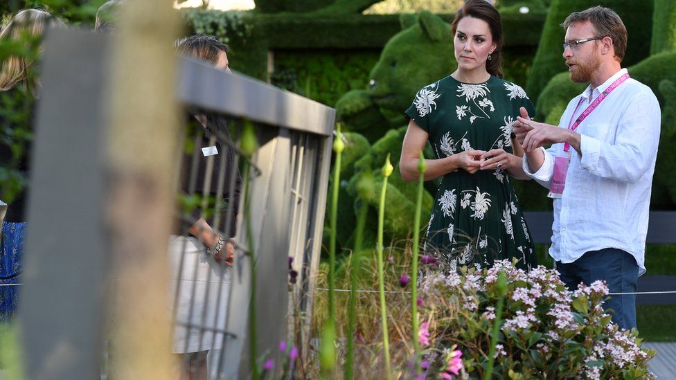 The Duchess of Cambridge talks with Ian Price at his garden "Mind Trap" at the Chelsea Flower Show in London
