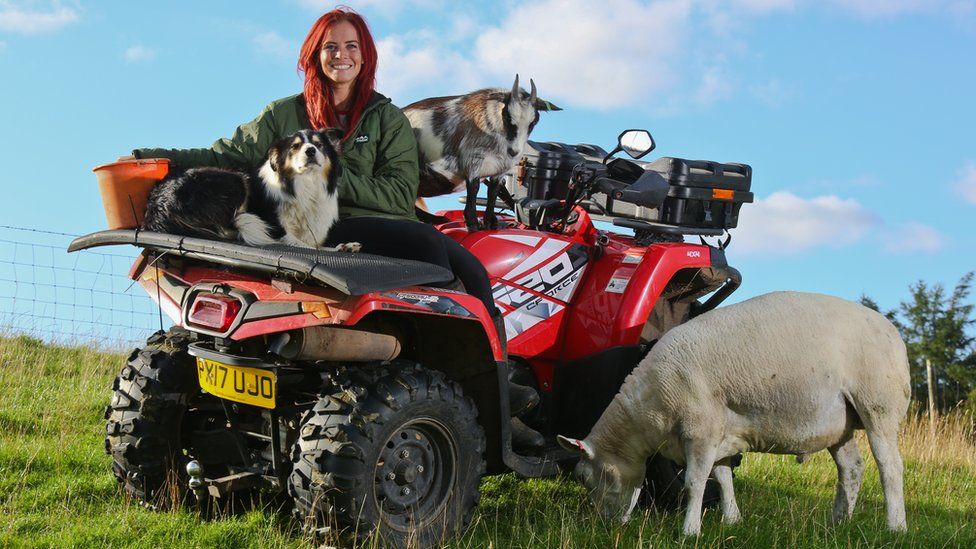 Hannah Jackson with some of her animals on her quad bike