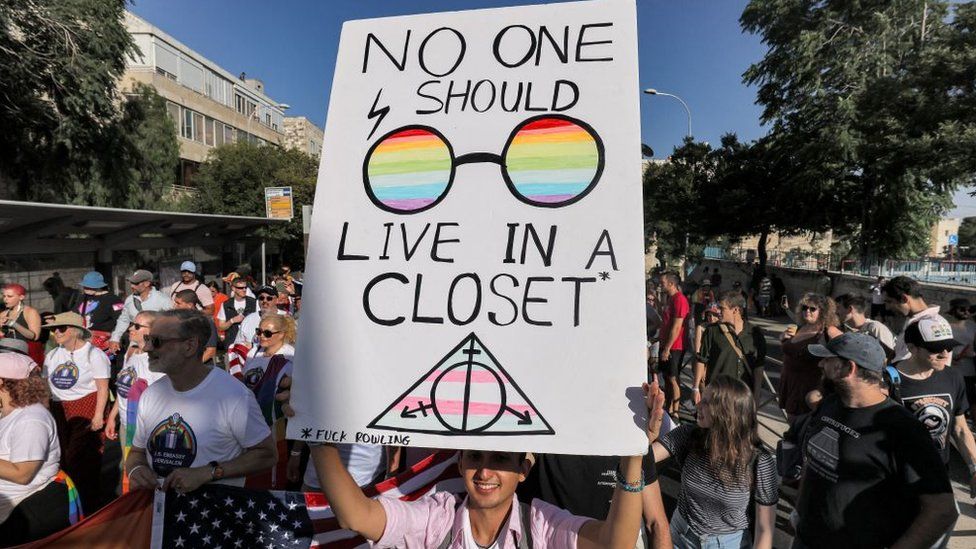 A sign reading "no one should have to live in a closet