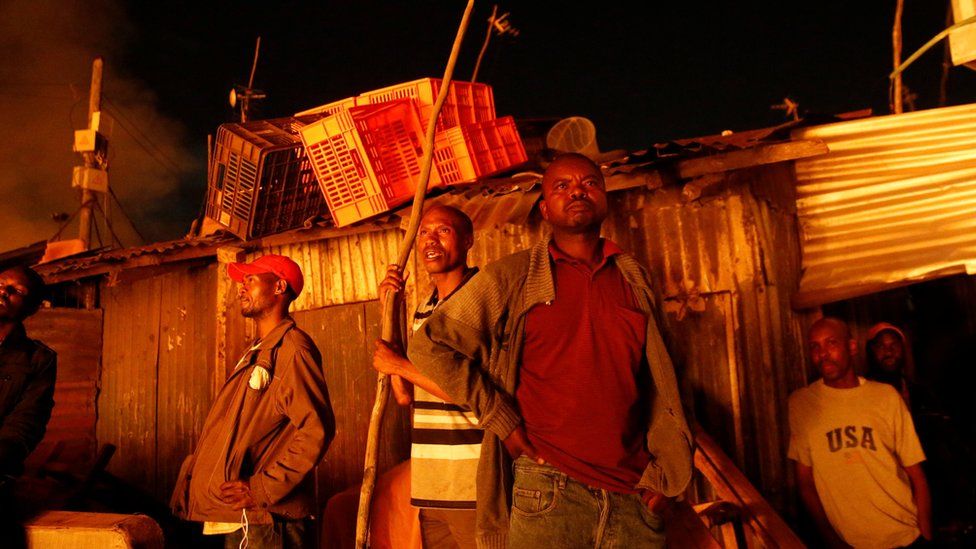 Residents watch as their houses burn in a fire that broke out at the Kijiji slums in the Southlands estate of Nairobi, Kenya, January 28, 2018