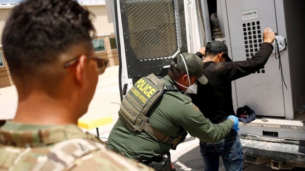 US border patrol officials detain a migrant in the US state of New Mexico. File photo