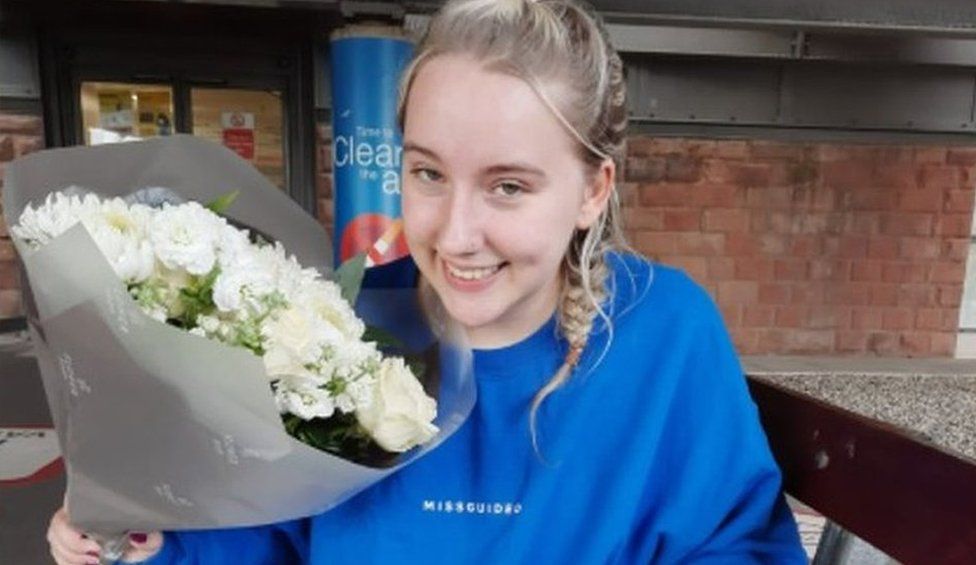 Tilly outside hospital with flowers