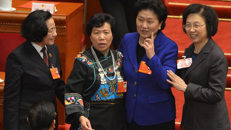 Four female delegates pose for a photograph at China's National People's Congress in the Great Hall of the People in Beijing on March 16, 2013.