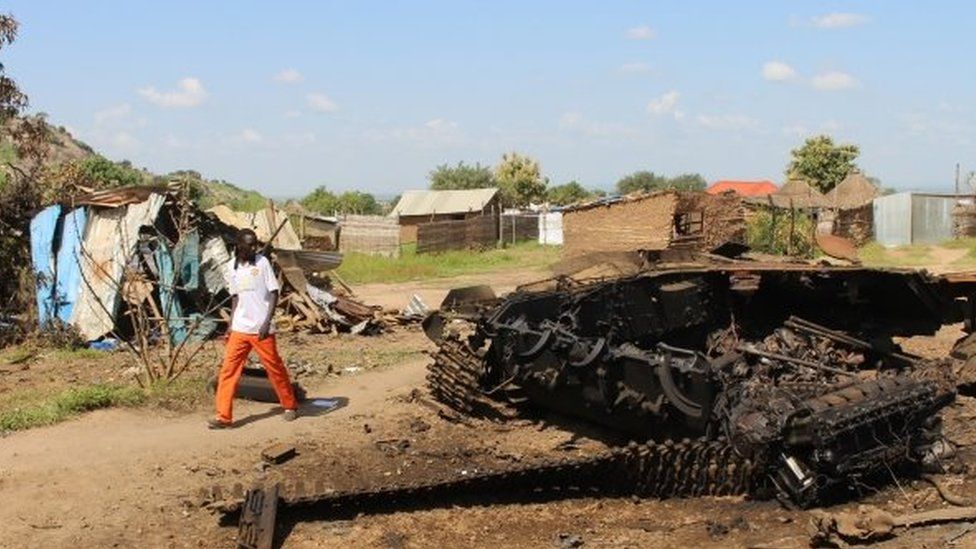 A man walks past a destroyed tanks in Juba. Photo: July 2016