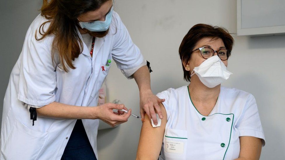 Picture of French woman being vaccinated