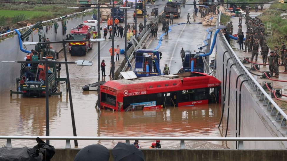 A bus is brought out of a flooded underground tunnel after flood water submerged 15 vehicles in the central town of Osong, South Korea, 16 July 2023. Seven people are confirmed to have been killed so far in the tunnel.