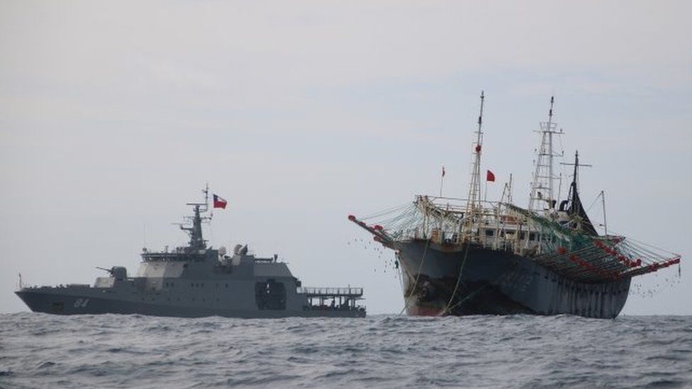 One vessel, part of a fleet of hundreds of Chinese fishing boats, sails next to a Chilean Navy ship in Pacific Ocean international waters near Chile"s exclusive economic maritime zone, off the coast of Arica and Parinacota November 30, 2020.