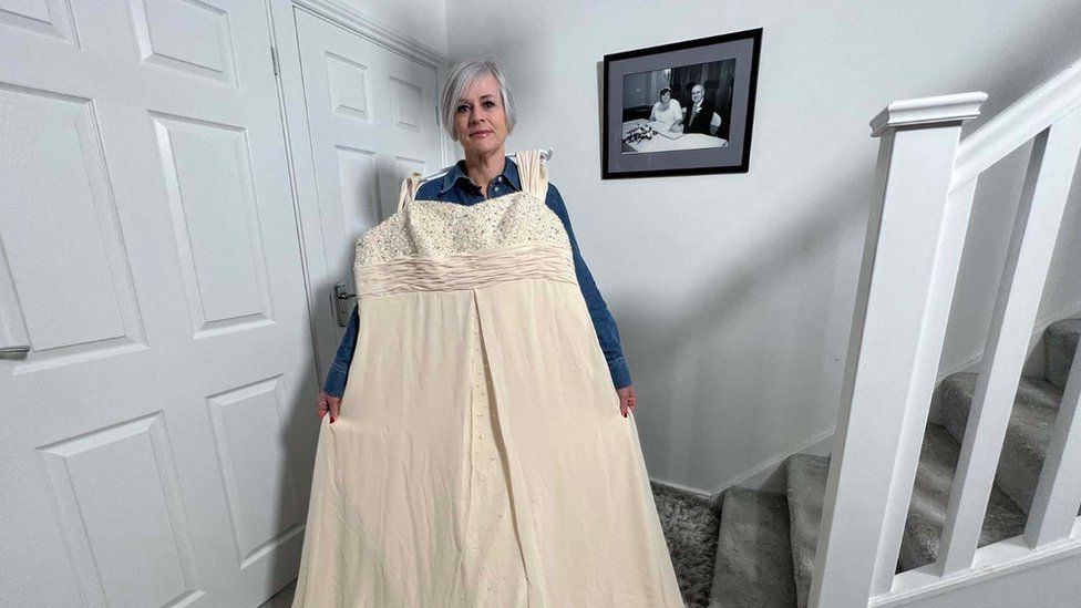 Jenny Evett at her home in Milton Keynes with her size 28 wedding dress