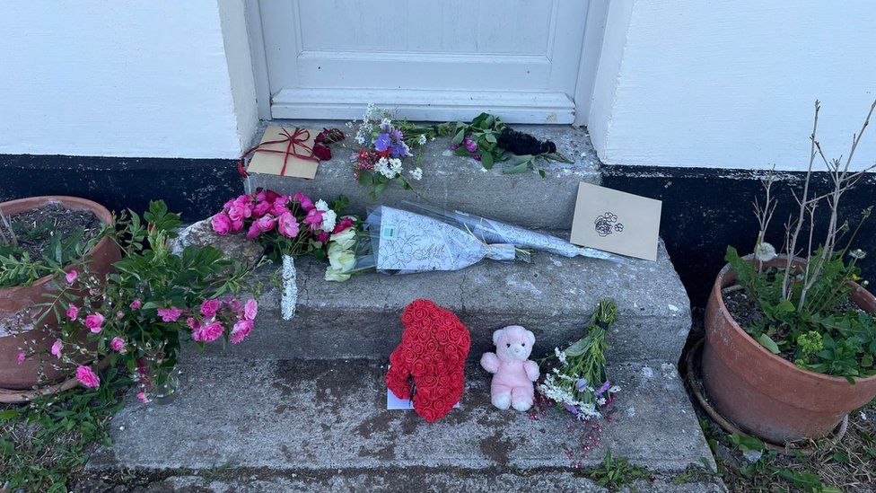 Flowers and teddies have been left on the family's front door step
