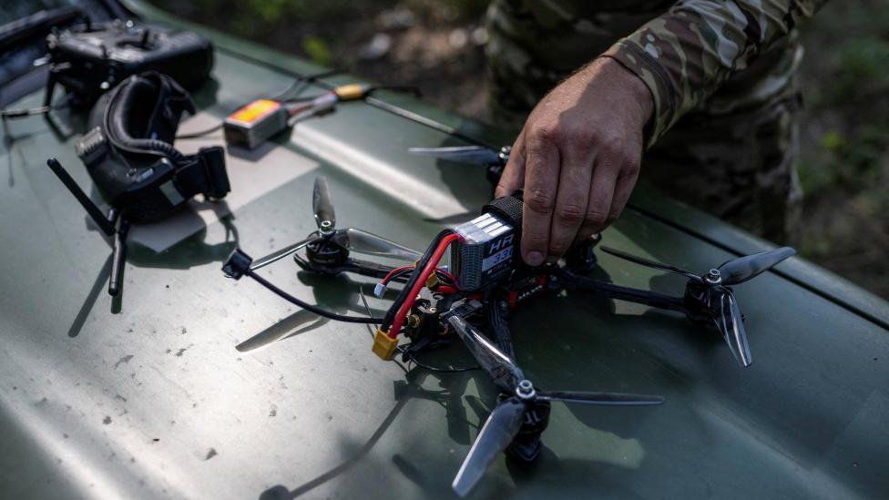 The hand of a Ukrainian serviceman rests on an FPV drone in Zaporizhzhia region
