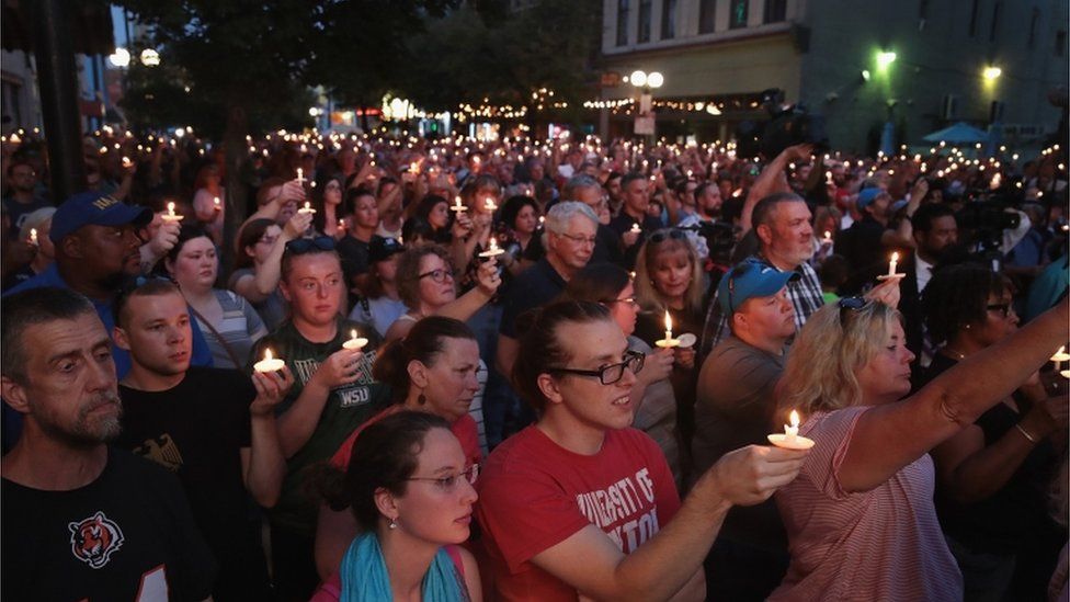 Mourners attend a memorial service in the Oregon District to recognize the victims of an early-morning mass shooting in the popular nightspot