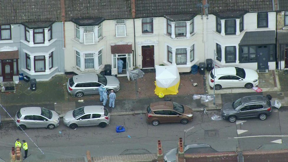 Forensic officers can be seen investigating a home in Ilford