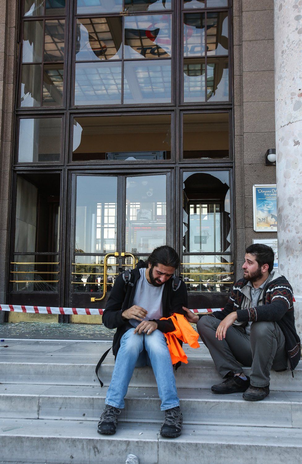 Survivors of blasts in Ankara sit on the steps of the railway station, Turkey - Saturday 10 October 2015