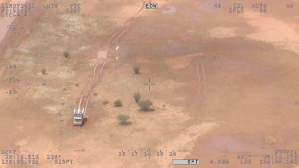 An aerial view of the campervan in the sparsely vegetated Simpson Desert