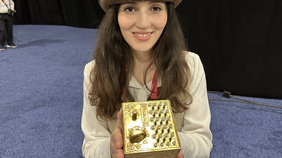 lady holding Ohm's Quest box