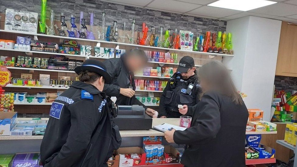 Police raiding a store in Bromsgrove