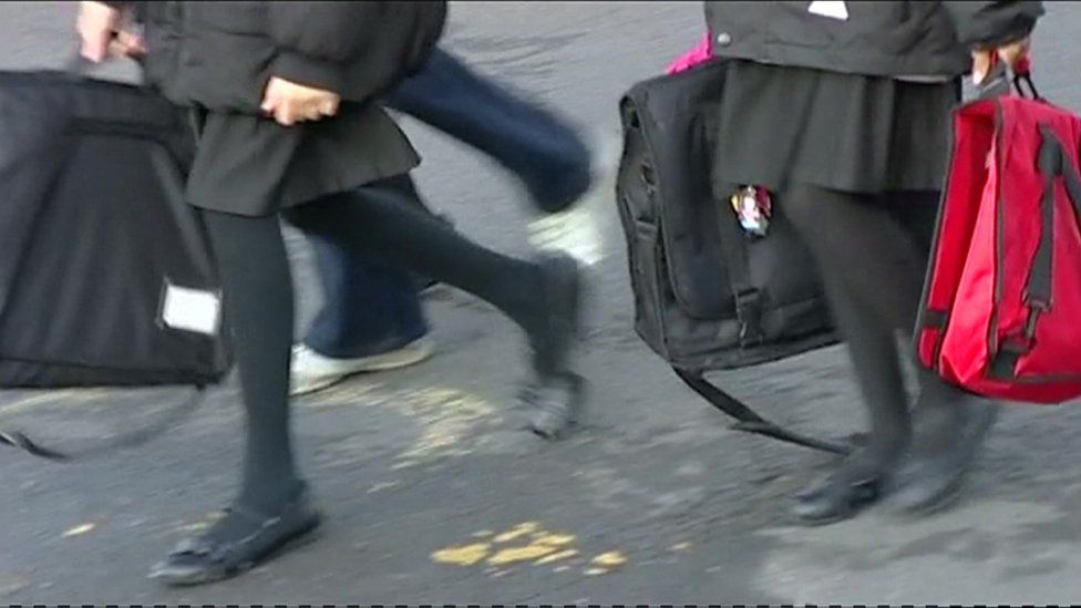 Girls walking away from school - anonymous