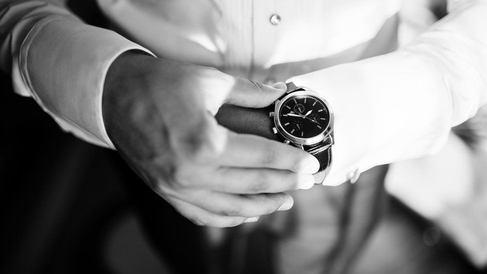 A man checking the time on his watch