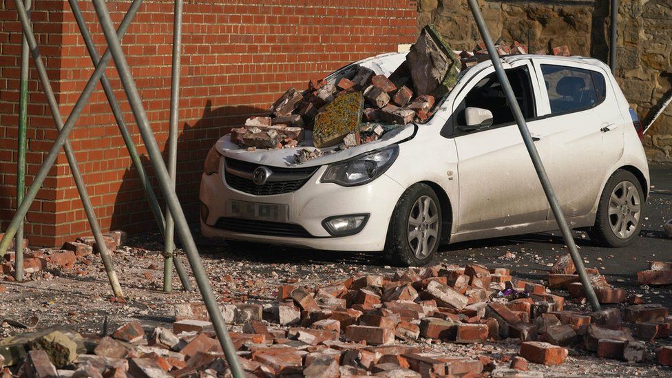 A car crushed by fallen bricks in Seaton Sluice, Northumberland