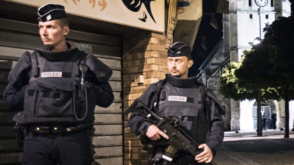 French police stand guard at the scene of a stabbing by Islamist militants near Rouen