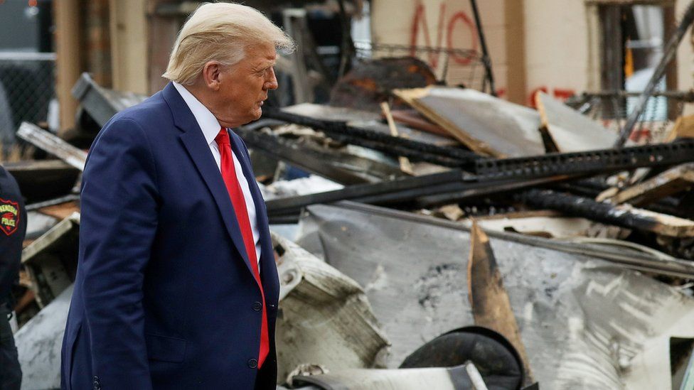 US President Donald Trump views property damage to a business during a visit to Kenosha in the aftermath of protests following the shooting of Jacob Blake by police in Kenosha, Wisconsin.
