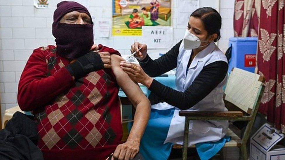A health worker inoculates a man with a third dose of the Covaxin vaccine at a vaccination centre in New Delhi on January 10, 2022, as the country sees an Omicron-driven surge in Covid-19 coronavirus cases