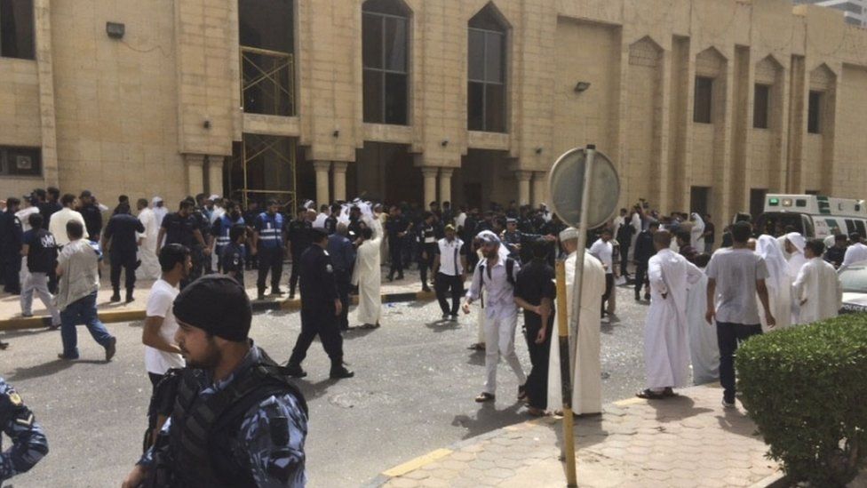 Security forces, officials and civilians gather outside of the Imam Sadiq Mosque after a deadly blast struck in Kuwait City on 26 June 2015.