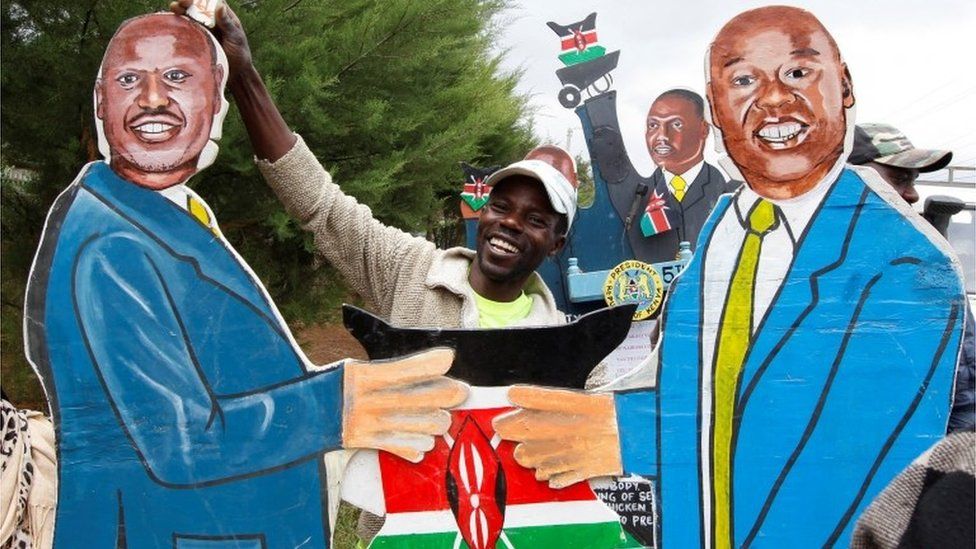 vendor holds an artistic expression representing Kenya