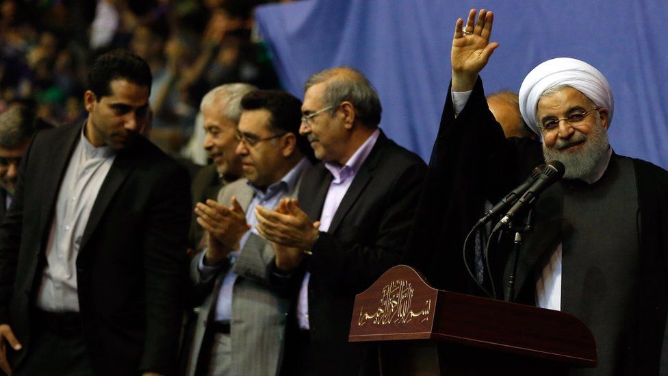 Hassan Rouhani waves at a campaign rally