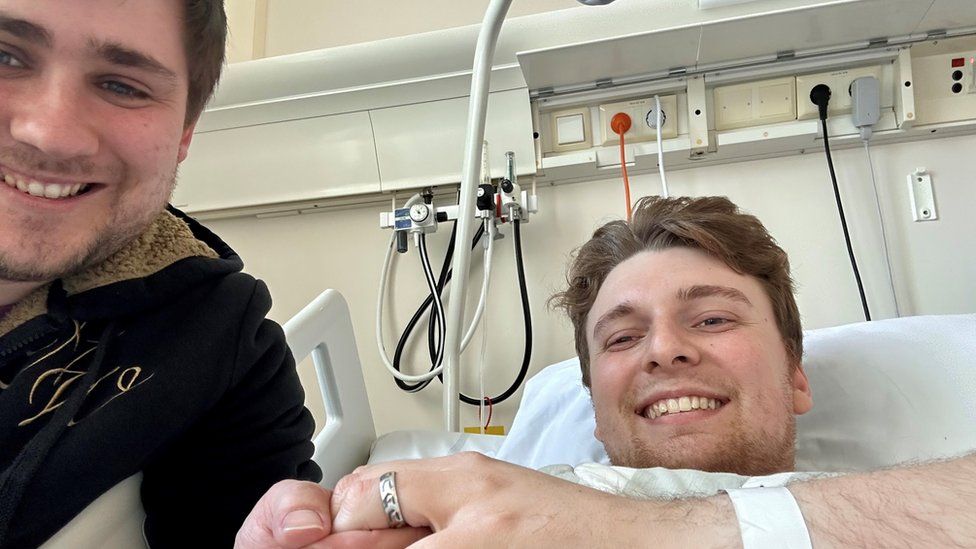 Zak Nelson and Elliot Griffiths in hospital, smiling